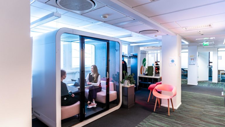 Women sitting in Framery Q soundproof meeting pod