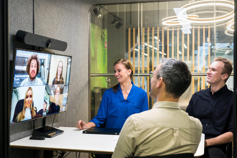 People working in Framery 2Q Huddle with Logitech devices