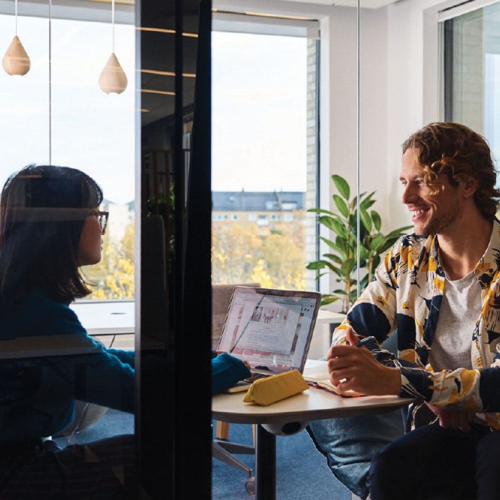 People working inside an office pod.