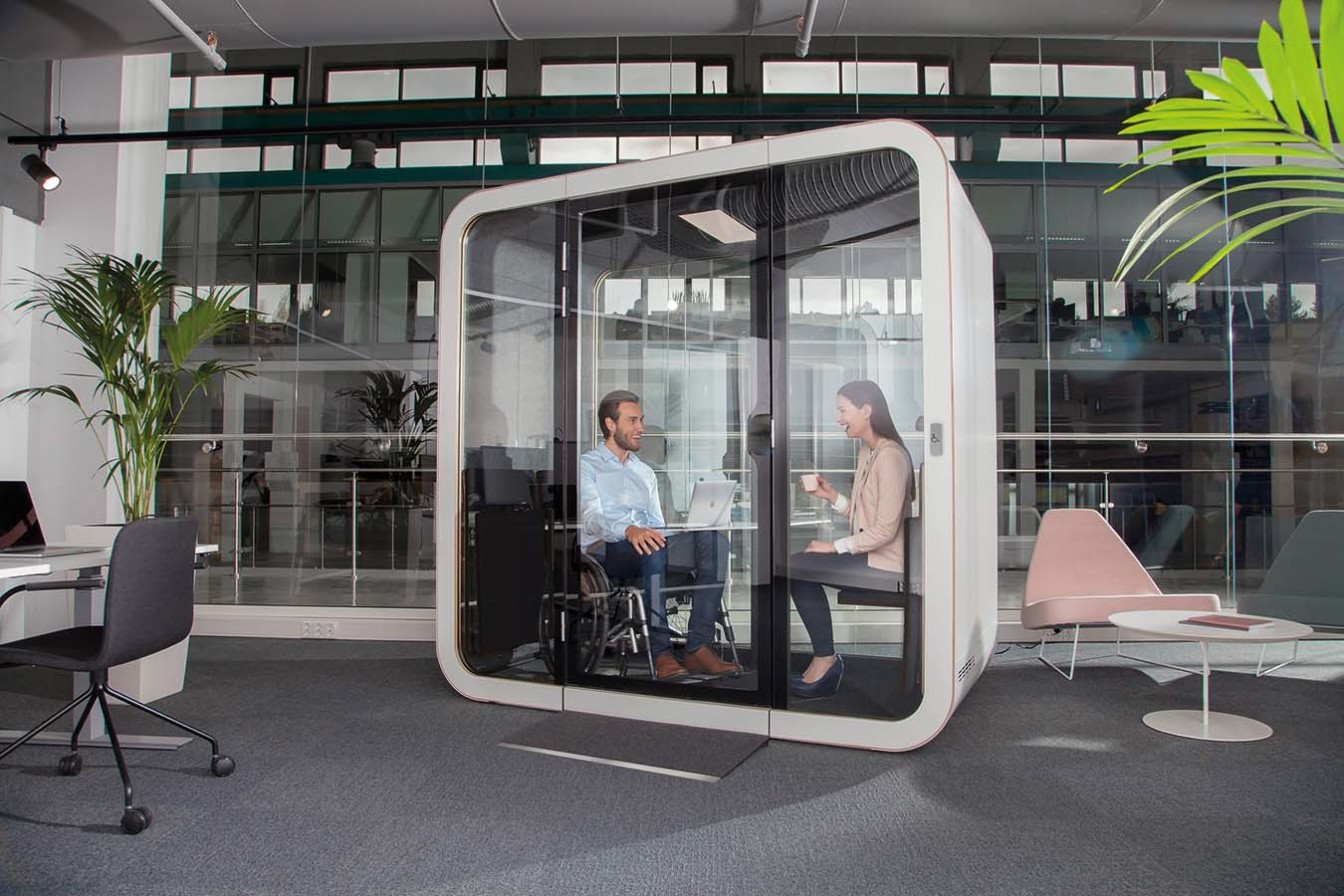 Soundproof Framery pod providing a quiet space for meeting between two people in an open-plan office.