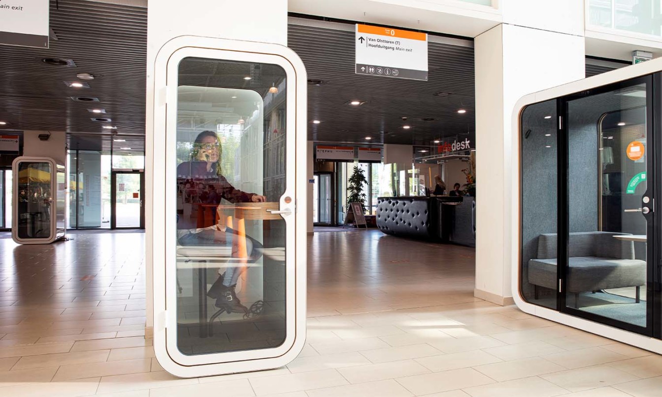 Student talking in the phone inside a Framery O office phone booth