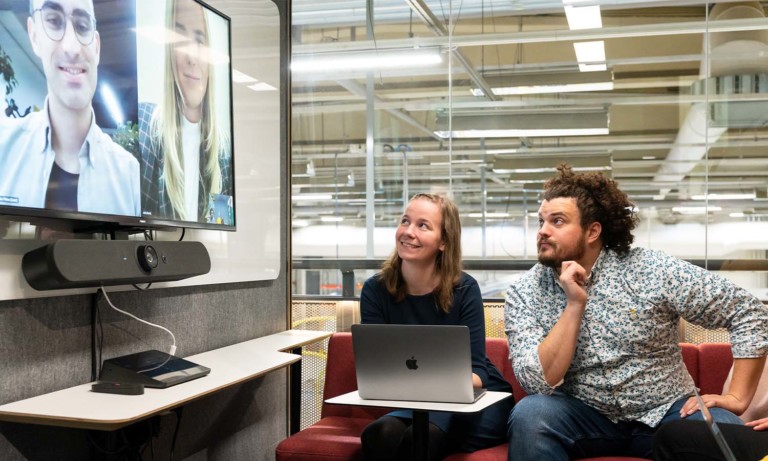 People having a virtual meeting in a Framery 2Q meeting room.