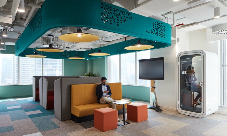 A person using a Framery O office phone booth in Linkedin headquarters in Dubai.