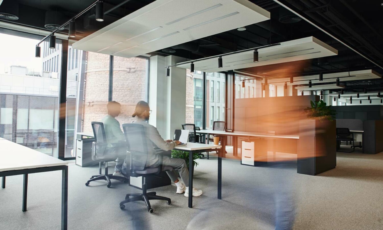 People working in open-plan office.