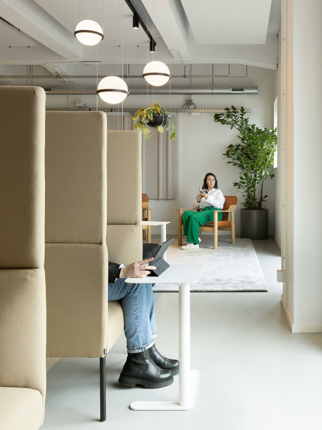 Woman sitting in a lounge chair at an office lounge.