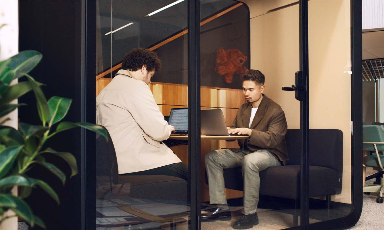 People working in a Framery Four meeting pod.