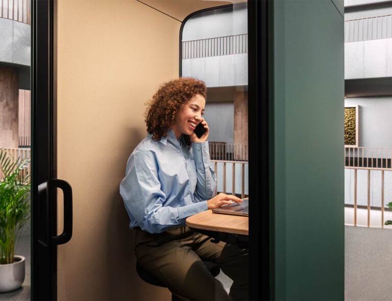 A person in a phone call inside a Framery call pod.