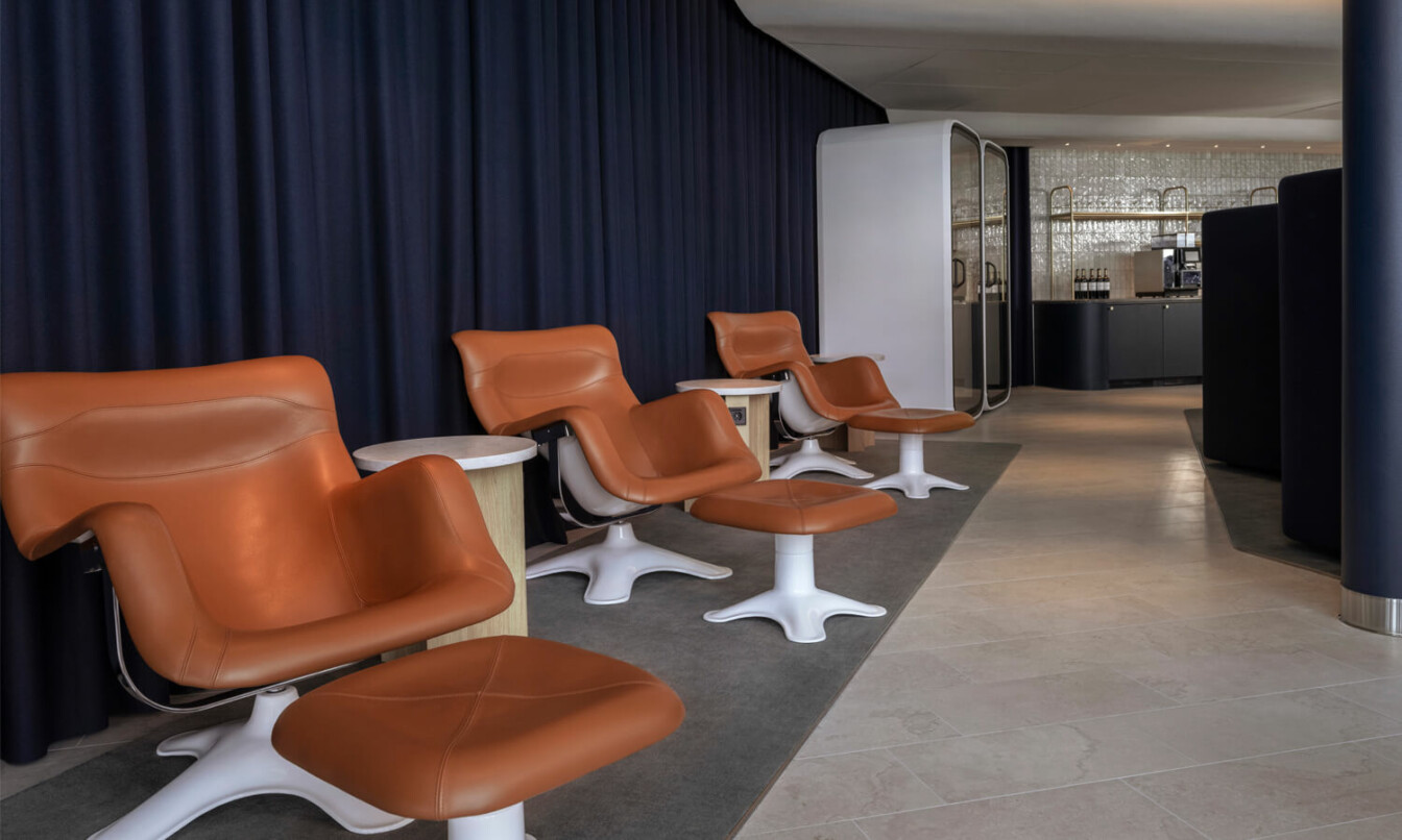 Design chairs and Framery One pods at airport lounge.