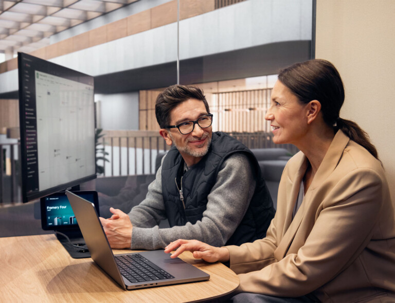 People having a conversation inside a Framery Four meeting pod.