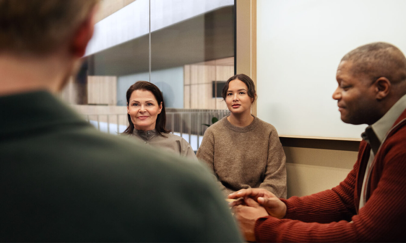 People working inside a Framery Six meeting room.