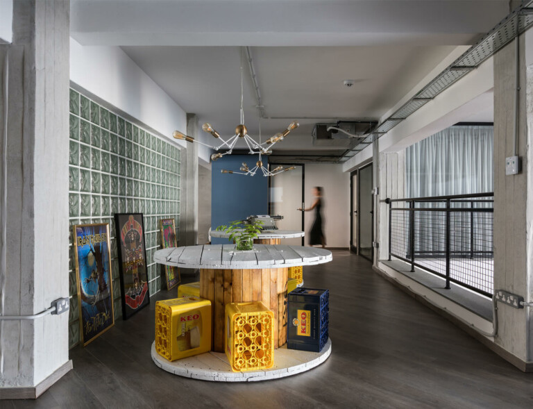 A DIY style office hallway with a blue Framery pod in the background.