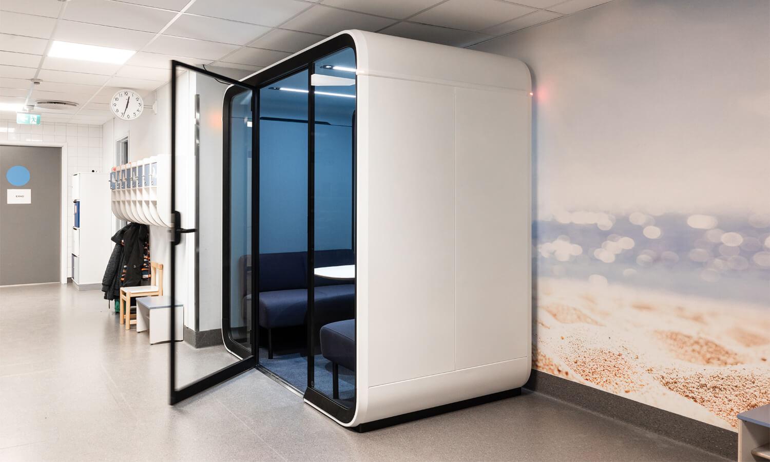 An empty school corridor with a study pod