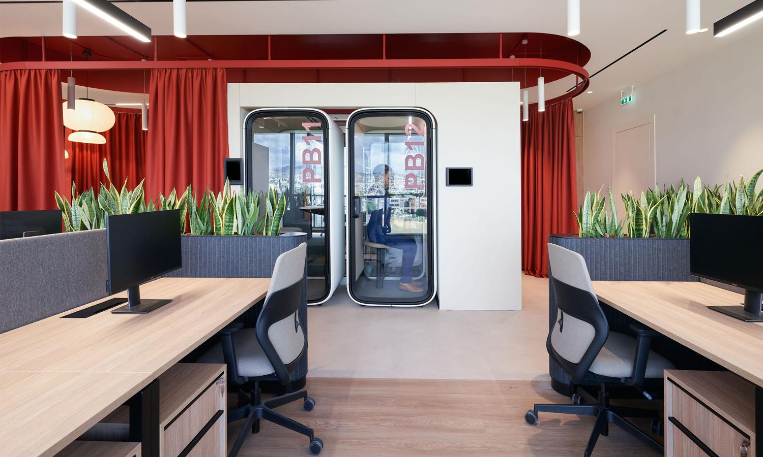 Two Framery One Compact pods integrated into an office wall structure.