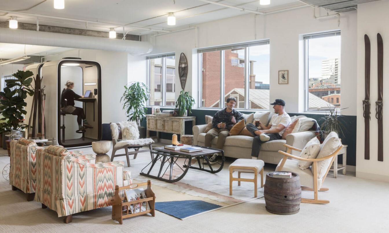 A light and cozy office lounge area with Framery One smart pod in the back.