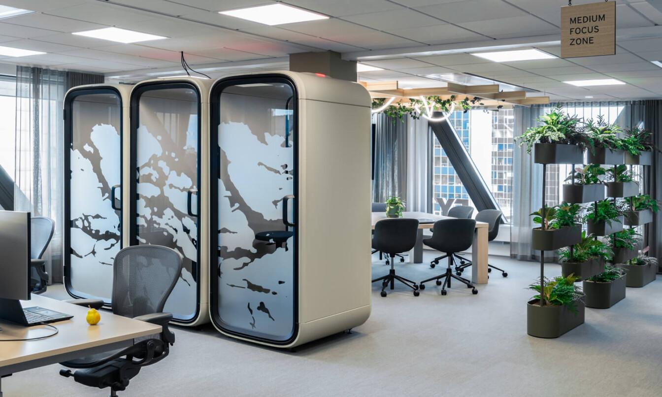 Office with one person office pods and working zones.