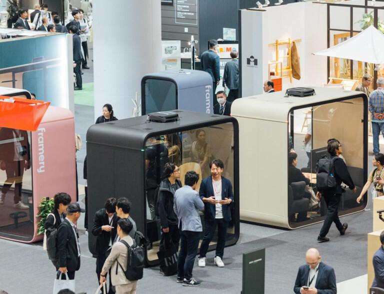 Framery fair stand at Orgatec Tokyo fair with lots of pods and people