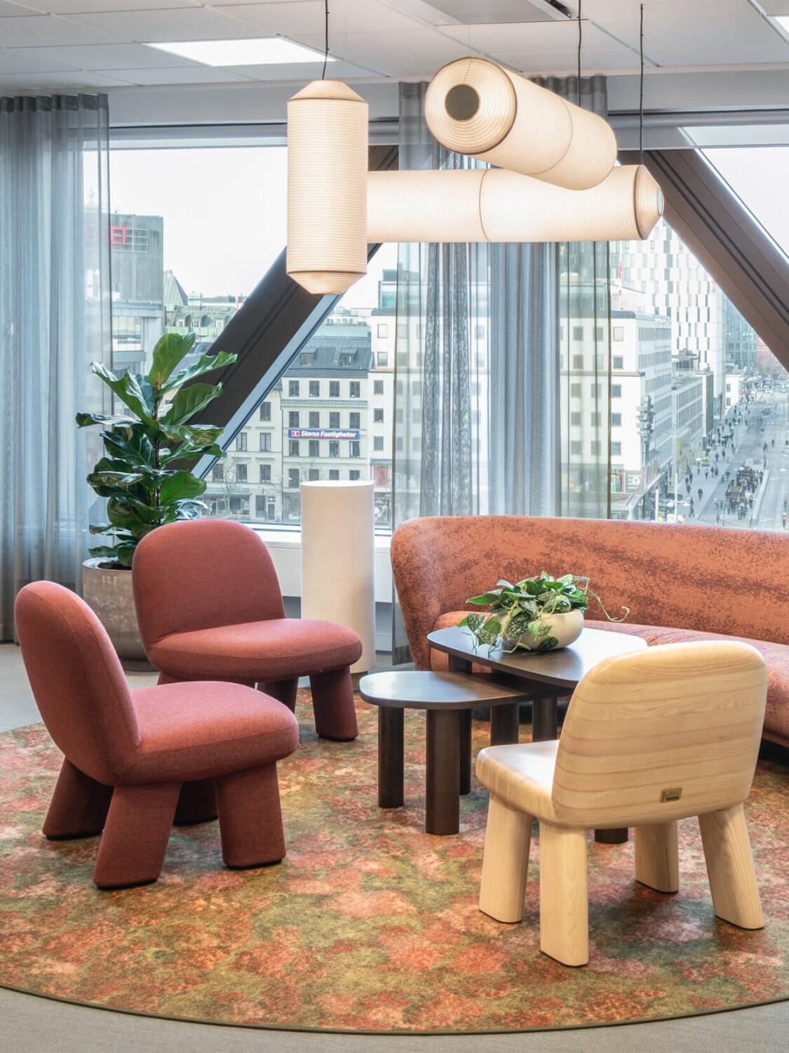 Earthy red and neutral toned office lobby with design furniture.