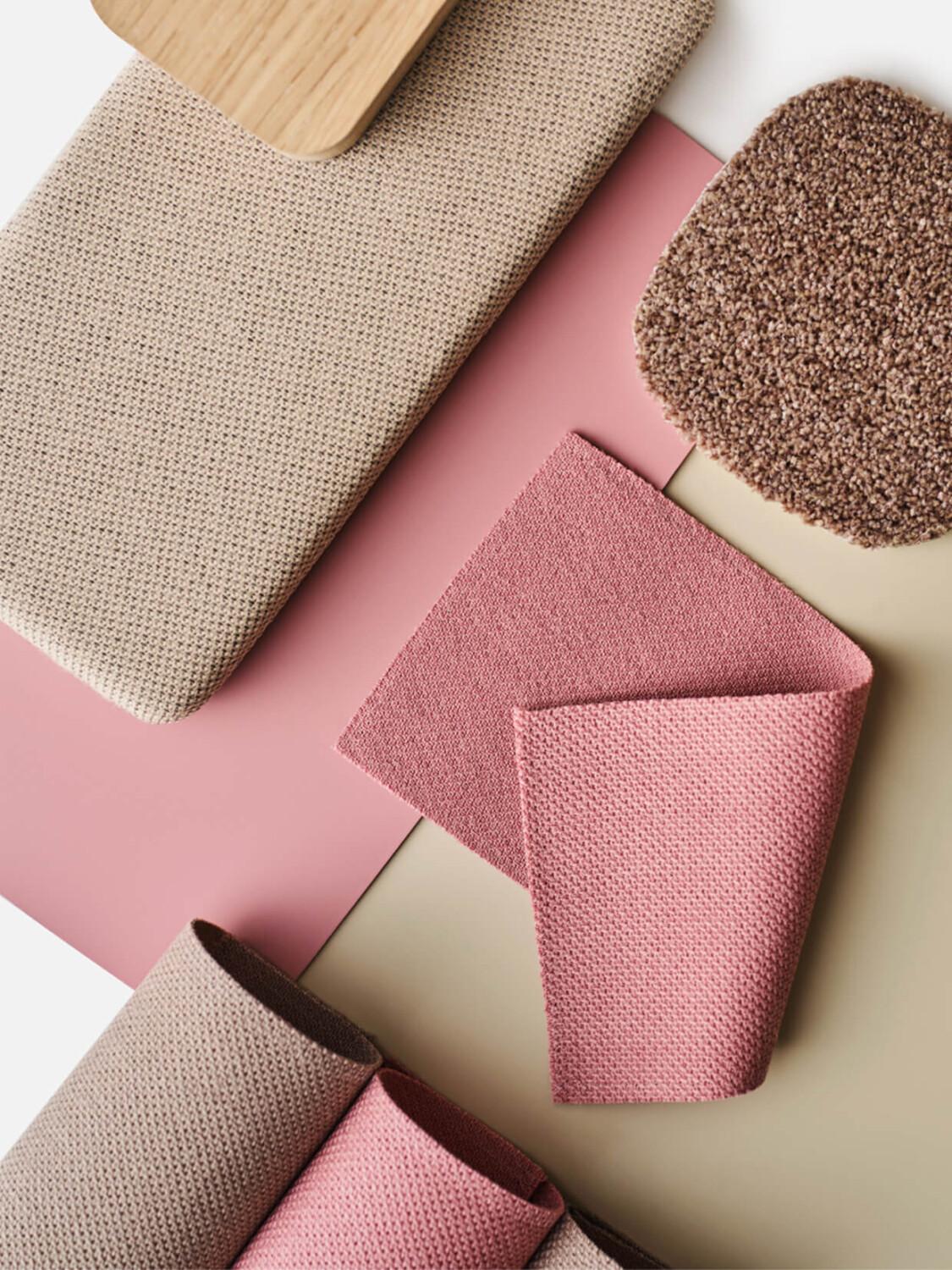 A flat lay of blush and beige fabric and material samples.