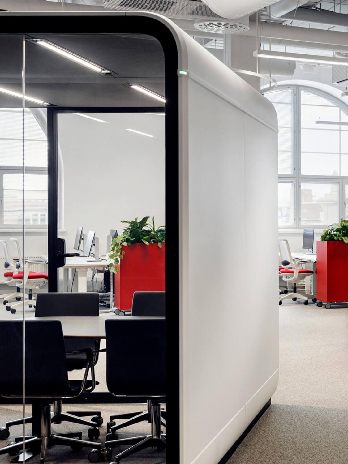 A close up of Framery Six meeting pod with an office setting behind.
