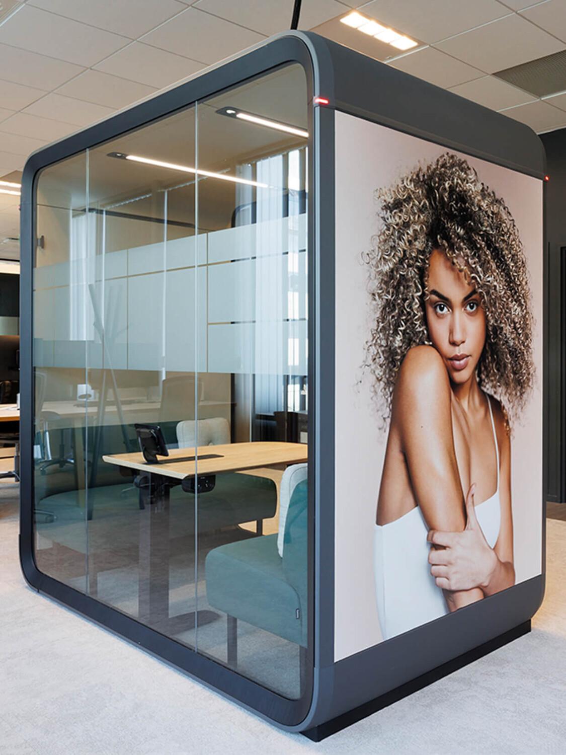 A Framery Four meeting pod with sofa seating and branded foil.
