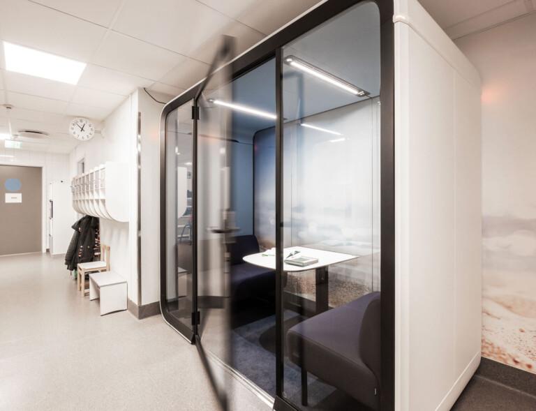 A white Framery Four study pod in a school corridor.