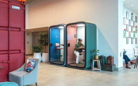 Framery smart pods at a colorful hotel lobby.