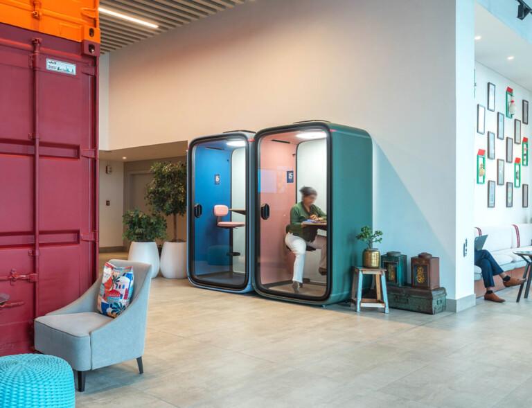Framery smart pods at a colorful hotel lobby.