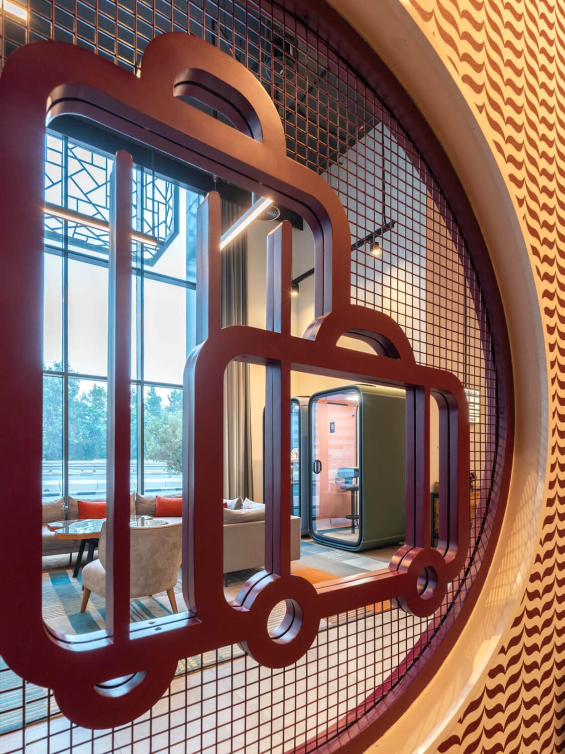 A wall decoration of luggage and Framery pods visible from behind.