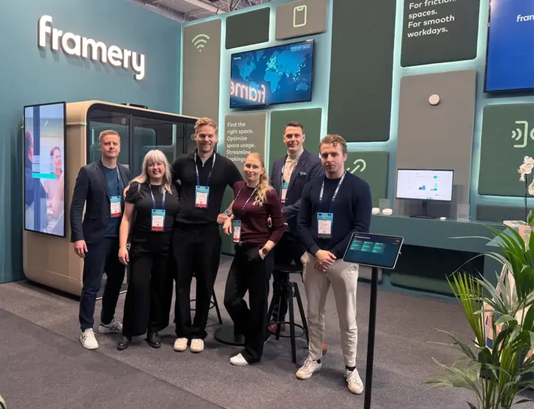 A group of smiling people standing in front of a Framery fair stand at ISE Barcelona 2026.