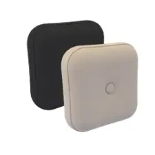 Two square, button-tufted cushions, one black and one beige, are positioned side by side against a plain, white background.