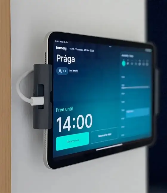 Tablet mounted on a wall with a silver bracket, displaying a digital dashboard with a large 14:00 time.