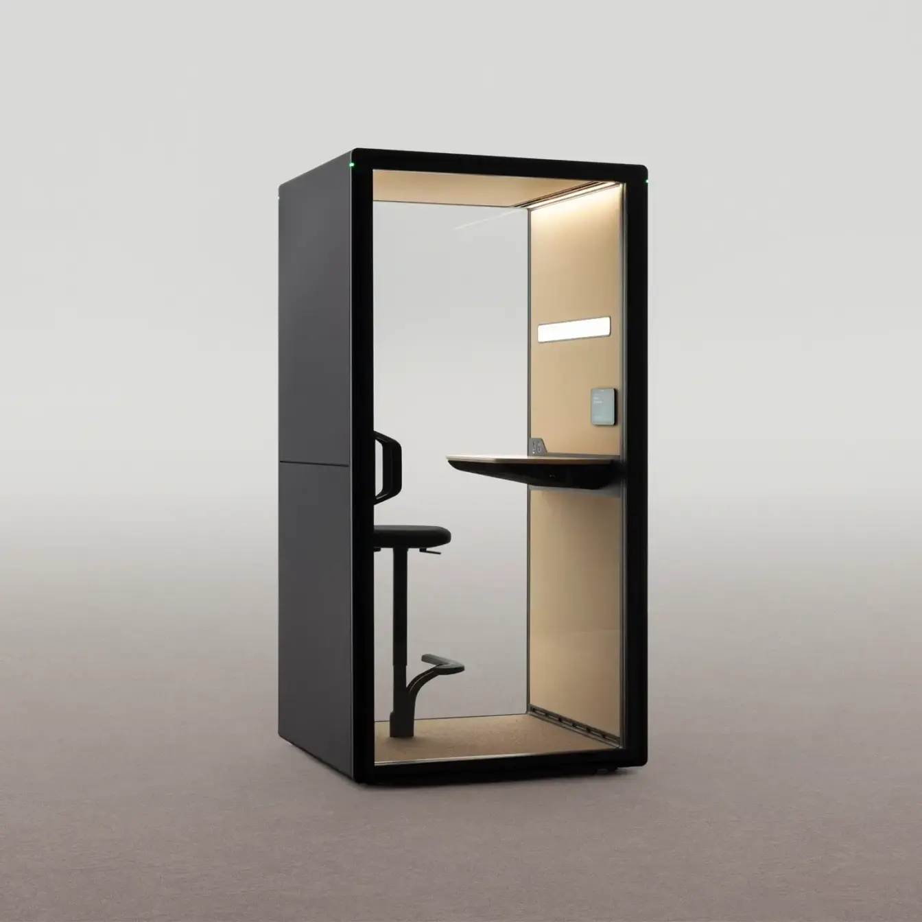 A compact black-framed Framery Gradus Focus privacy booth with a built-in desk and a stool inside.