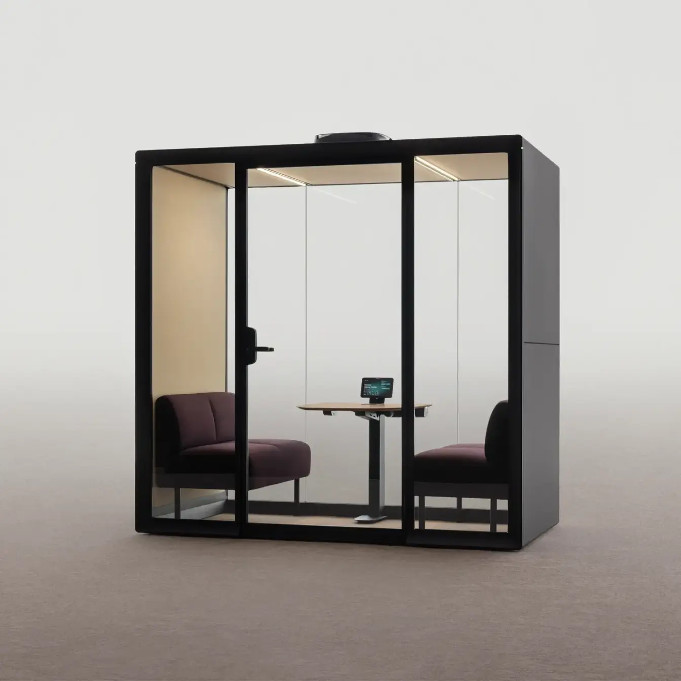 A black-framed Framery Gradus Huddle room with two chairs and a small table holding a laptop.