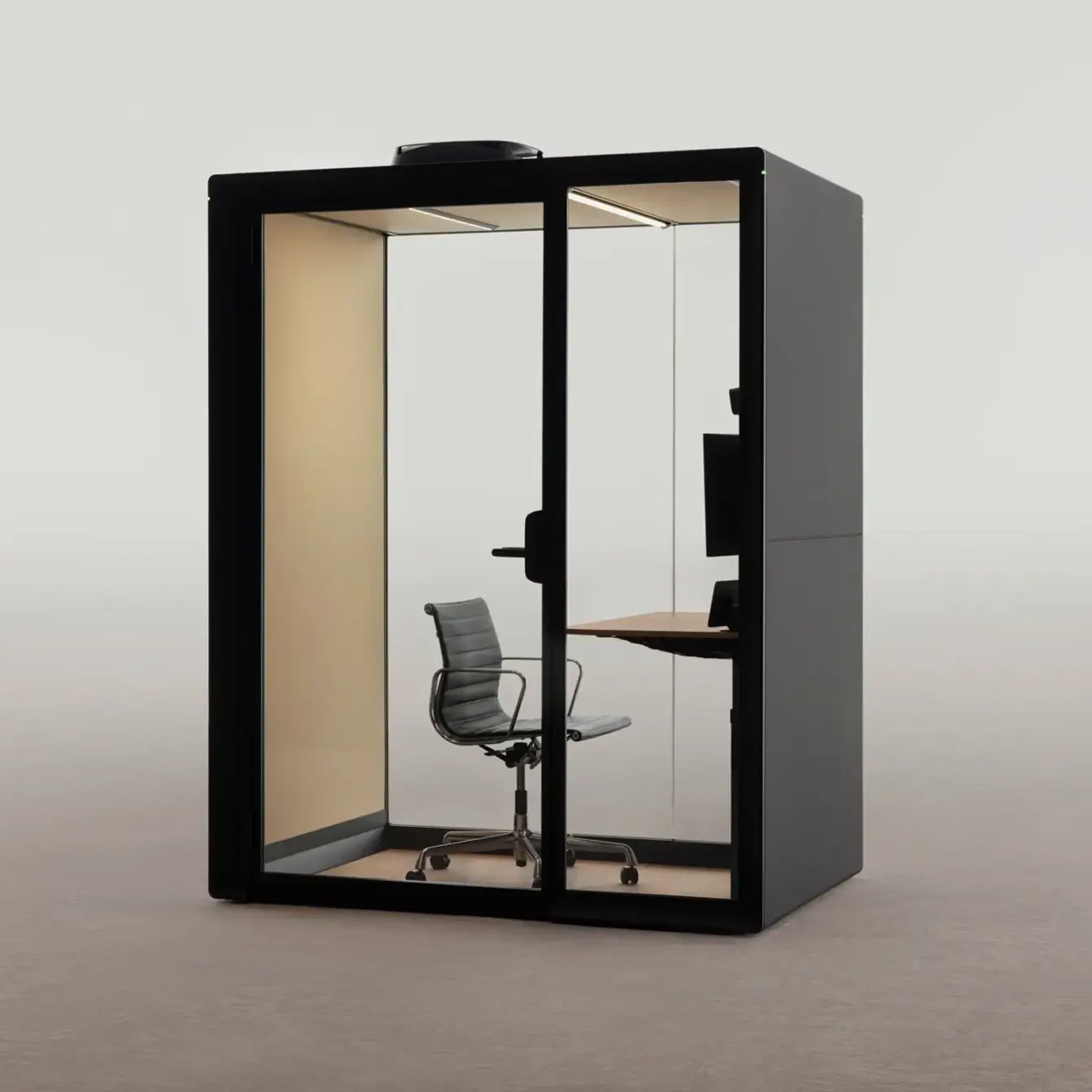 A black glass-walled Framery Gradus Work smart pod with a desk and swivel chair inside.