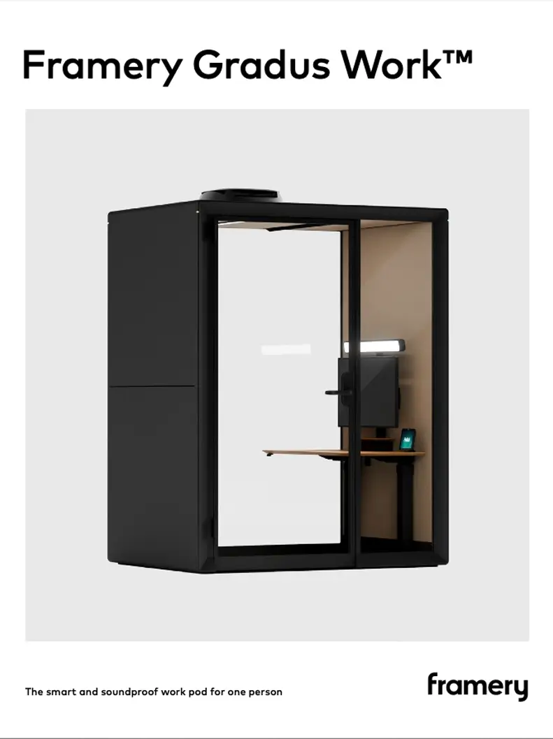 A black exterior Framery Gradus Work soundproof work pod with a glass front door and a small desk inside.