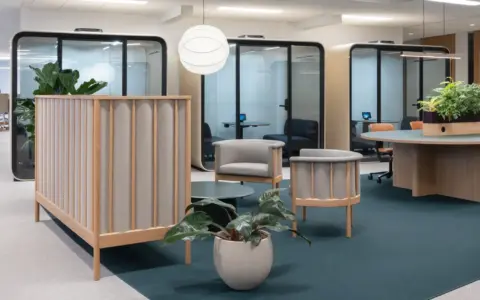 A light and modern office with Scandinavian interior with a row of Framery Four meeting pods in the back.