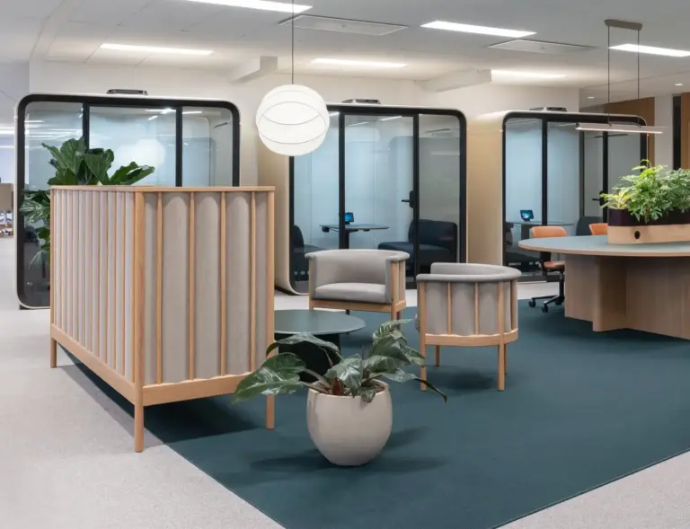 A light and modern office with Scandinavian interior with a row of Framery Four meeting pods in the back.