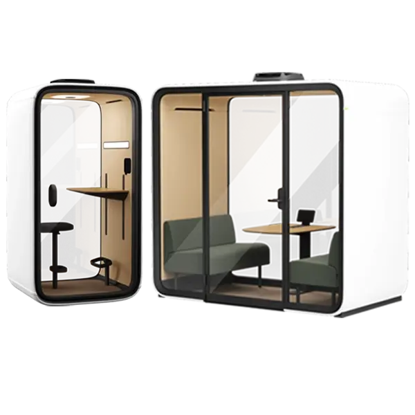 A white modular camper pod with glass walls and two rooms: a small workspace on the left and a living area with a sofa and table on the right.