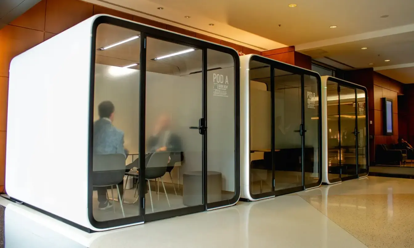 A Framery Six meeting space and two Framery Four meeting rooms in a bright lobby.