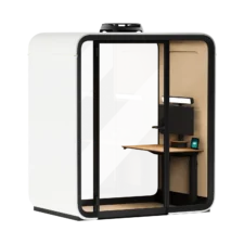 Modern glass-front private Framery One Work office workstation pod with a glass door, an interior desk, and a wall mounted monitor.