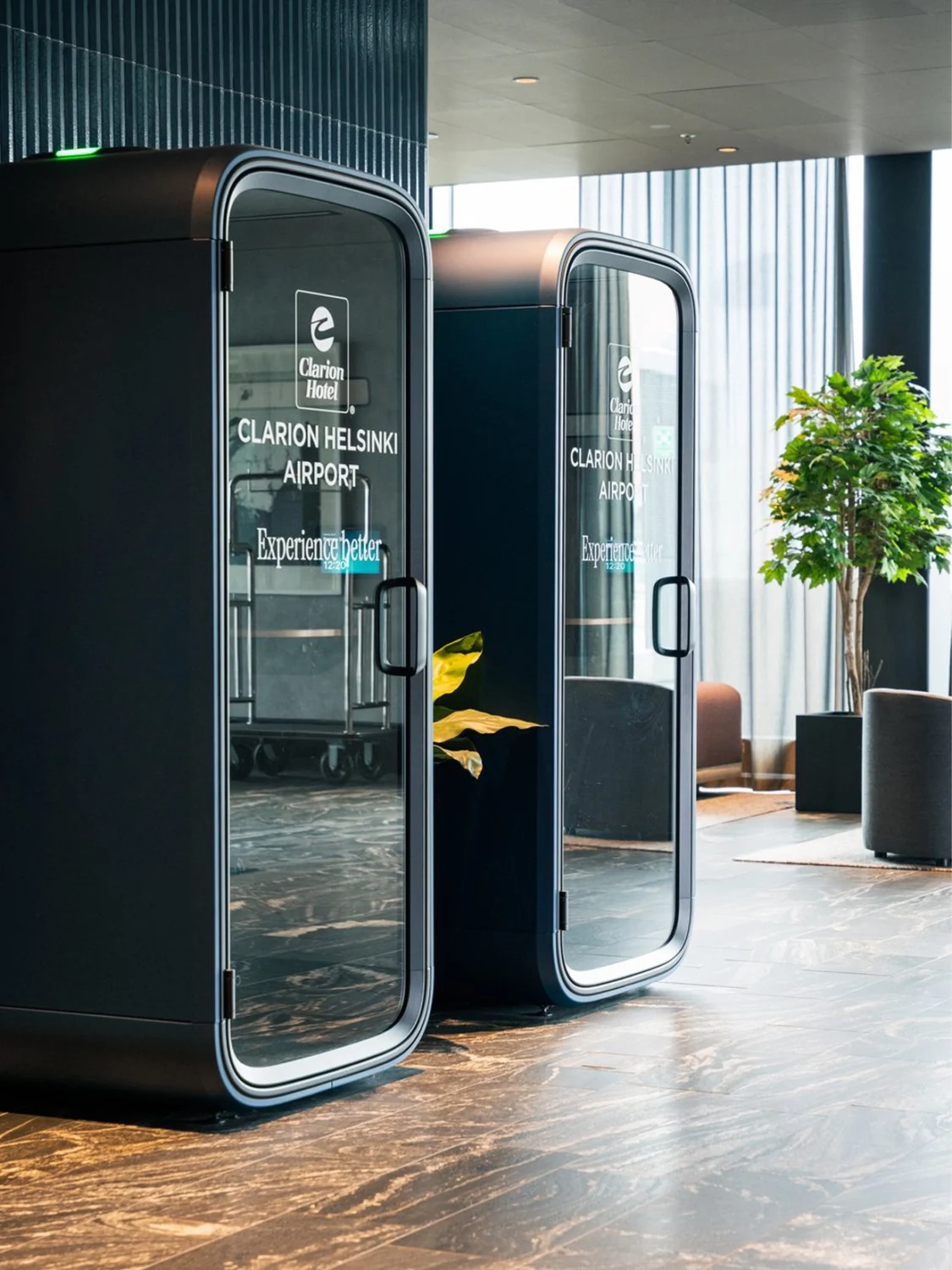 Two Framery Subscribed rental pods in a modern lobby, labeled "Clarion Helsinki Airport."