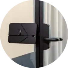 Close-up of a black tablet mount on a glass door.